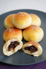 Chinese dessert: a plate of small bread filled with bean paste. Chinese breakfast on a plate of small bread filled with bean paste.