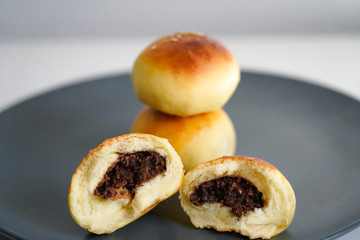Chinese dessert: a plate of small bread filled with bean paste. Chinese breakfast on a plate of small bread filled with bean paste.
