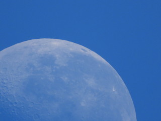 Closeup of the moon against blue sky