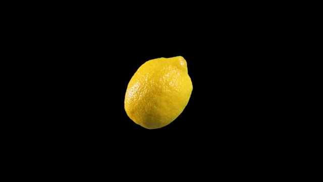 Slow motion of Real delicious yellow lemon spinning rotating and taken off green screen WITH ALPHA CHANNEL included
