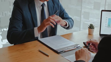 Senior manager reading a resume during a job interview employee young man meeting Applicant and recruitment concept
