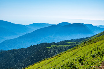 View over the Green Valley, surrounded by high mountains on a clear summer day
