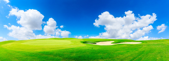 Naklejka na ściany i meble Green golf course and blue sky with white clouds,panoramic view.