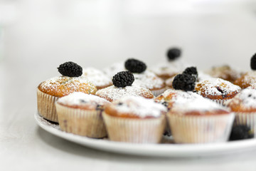 Plate with freshly baked sweet muffins. Sweet pastries, recipes, cooking