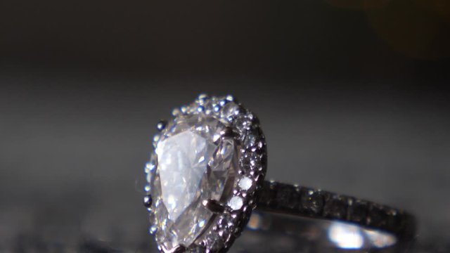 Close up, macro shot of precious white gold jewelry ring on the gray background