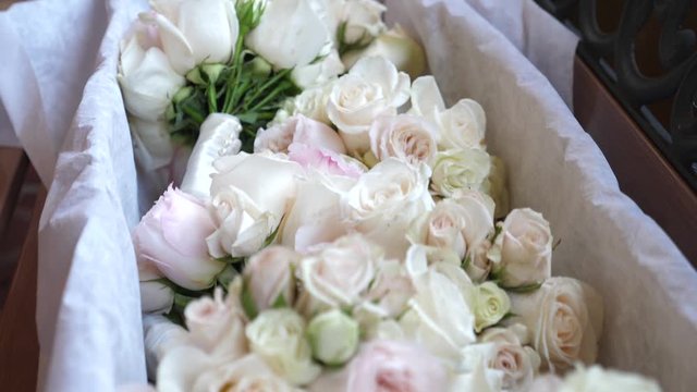 Wedding decoration. Beautiful fresh white roses over the silky linen on the hotel reception. Close up shot