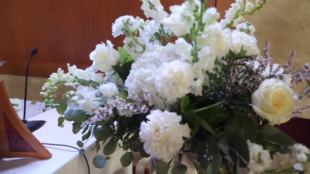 Indoors wedding decoration. Beautiful bouquet of garden white roses and lavender in the vase. Close up parallax shot