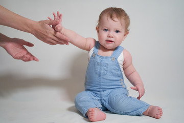one year old baby reaches for mom