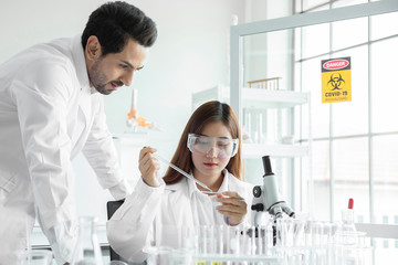 Young team scientist medical worker in lab , doing a analysis in a laboratory doing research