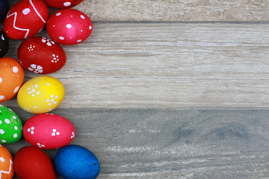 Top view colorful and decorated easter eggs on vintage wooden table background. Advertising image Easter festival concept with free space.