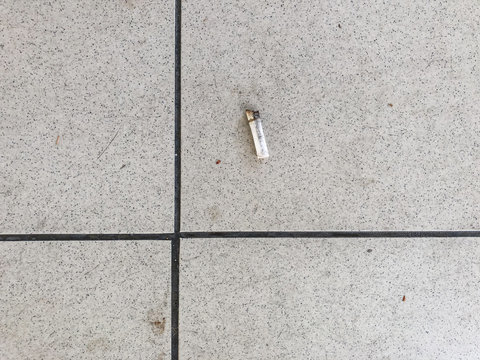 Smokers are littering cigarette butts on the public.