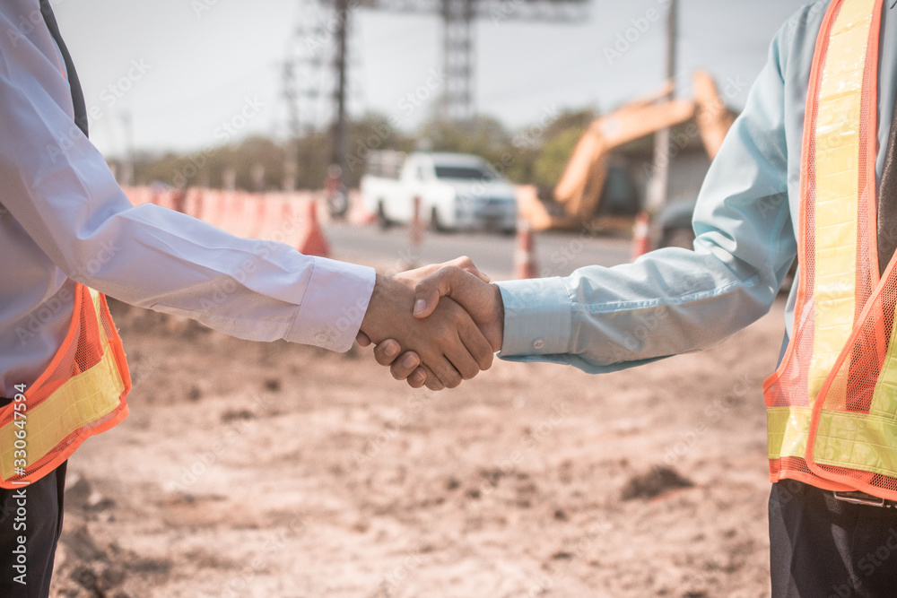 Wall mural businessman two people shake hand success at construction site partnership community