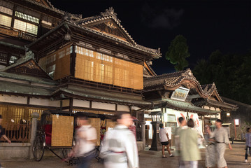 Dogo Onsen Honkan and tourists wearing Yukata at night, Matsuyama,...