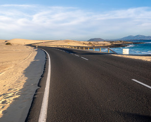 asphalt road running through the sands of Dunas Corralejo in Fuerteventura