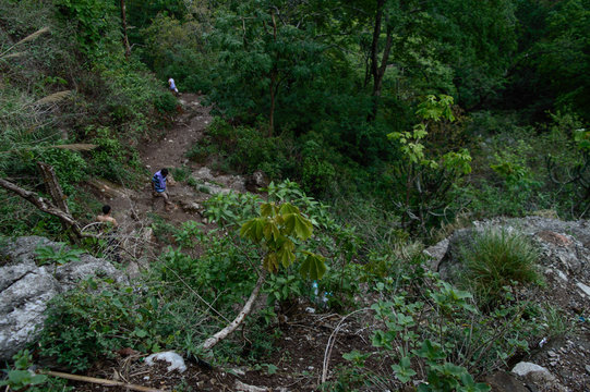 Group of people going down,trekking, from the famous neer garh Waterfall, Rishikesh, Uttarakhand India.