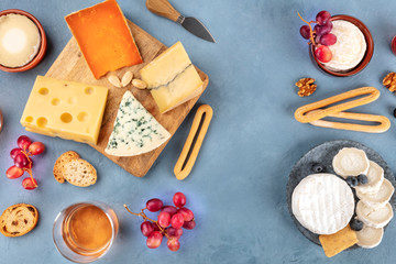 Fototapeta na wymiar Cheese assortment. Goat cheese, Camembert, blue cheese etc, shot from the top with copy space
