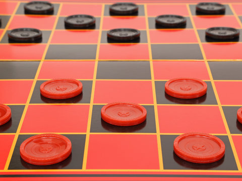 A game of checkers is shown set up on a standard red and black board, ready for the start of gameplay.