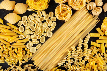 Italian pasta variety, a flat lay of various pasta types, shot from above on a black background