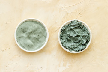 Blue cosmetic clay on beige background top-down