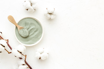 Blue cosmetic clay on white background top-down copy space