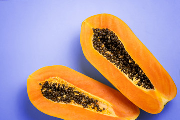 Ripe papaya on blue background