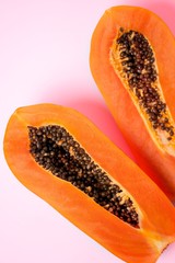 Ripe papaya on pink background