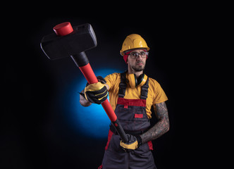 the male construction worker with a sledgehammer