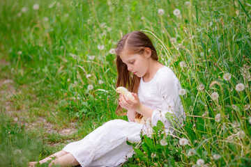 child girl with chicken hands playing on the grass
