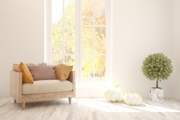 White stylish minimalist living room with armchair and autumn landscape in window. Scandinavian interior design. 3D illustration