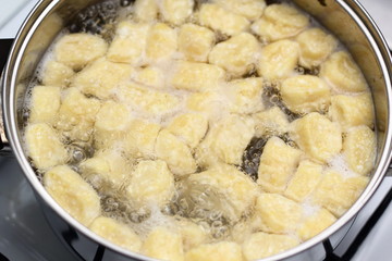 Gnocchi being prepared. Boiling. Dough dumplings with cheese.