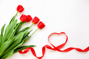 Red tulips and a ribbon heart . Valentine's day, mother's Day, wedding, women's day-concept