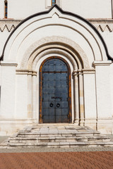 Ancient russian architecture. Close-up of arched metal door in russian style