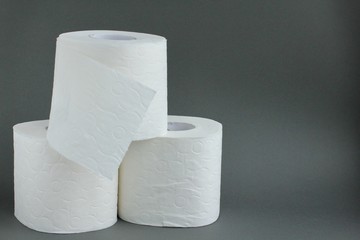 Toilet rolls on gray background. Concept of lack of toilet paper in stores due to coronavirus, Covid-19, hygiene, panic. Copy space.