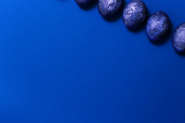 Eggs with marble stone blue effect painted with natural dye carcade flower on blue sparkling background