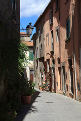 Scansano (GR), Italy - June 10, 2017: A central road and typical houses in Scansano, Grosseto, Tuscany, Italy