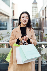 A young Asian woman is shopping at a shopping mall