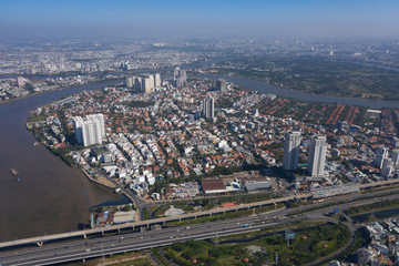 Naklejka na ściany i meble Top view aerial photo from flying drone of a Ho Chi Minh City with development buildings, transportation, energy power infrastructure
