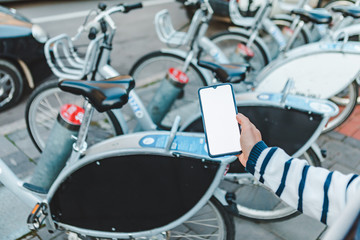 woman taking bike for rent with app