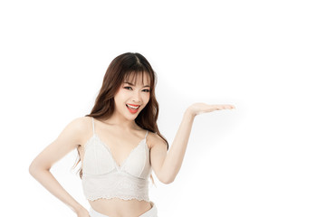 Fototapeta premium Portrait of attractive asian young woman with beauty skin and face present something on her hand isolated on white background. Healthy skin and face care concept.
