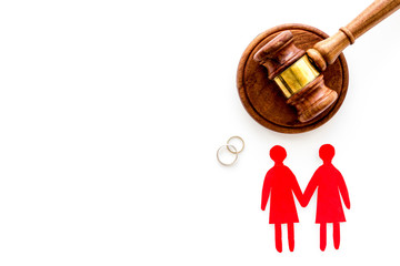 LGBT divorce. Judge gavel, rings, female couple on white background top-down copy space