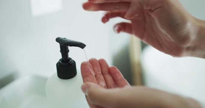 Corona virus travel prevention man showing hand hygiene washing hands with soap in hot water for coronavirus germs spreading protection. Using soap dispenser.