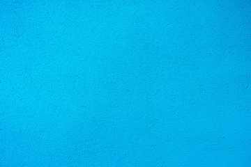 blue wall with a small fraction of plaster