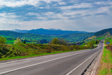 Naklejka premium Road through the hills at the countryside.