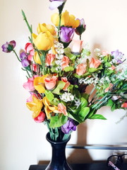 Vase of different colored flowers.