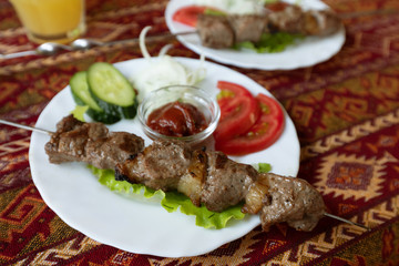 Barbecue on a table covered with a tablecloth in the national Tatar style