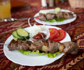 Barbecue on a table covered with a tablecloth in the national Tatar style