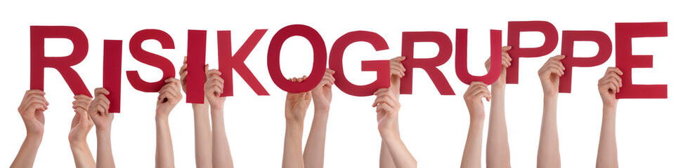 People Hands Holding Red German Word Risikogruppe Means High-Risk Group. White Isolated Background