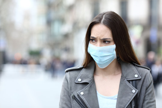 Scared Woman With Protective Mask Avoiding Contagion On Street