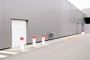 modern new grey warehouse hangar exterior with emergency exit door gate