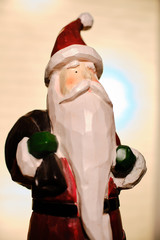 santa claus decoration in front of candle lights with room for copy
